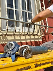 worker using a level, Working in a respirator, grinding metal with a machine
