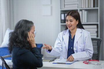 Doctor consulting senior patient in office, discussing health diagnosis and treatment options for better care.