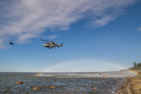 Royal Navy Fleet Air Arm Agusta Westland Wildcat HMA.2 Helicopter hovering over sea with rainbow effect