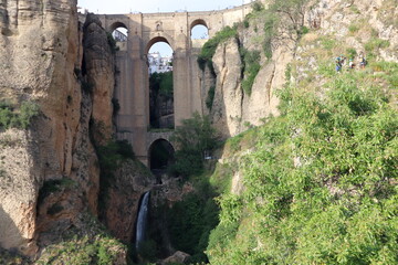 Rocky landscape of Ronda city with Puente Nuevo Bridge and buildings, Andalusia, Spain 