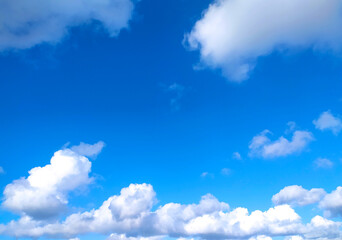 Clear blue sky texture and white fluffy cloud nature background. The sun shines bright in the daytime in summer