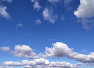 Clear blue sky texture and white fluffy cloud nature background. The sun shines bright in the daytime in summer