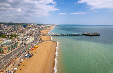 The drone aerial view of Brighton Pier and the beach of Brighton. The Brighton Palace Pier, is a pleasure pier in Brighton, England, located in the city centre opposite the Old Steine.