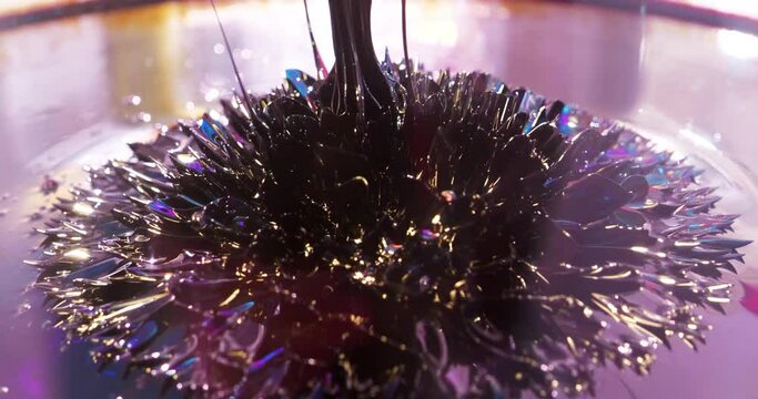 Ferromagnetic fluid. Real ferromagnetic fluid in action. Viscous ferrofluid spike-like shape. Ferromagnetic fluid creates amazing drawings spikes in magnetic field, appearing and disappearing