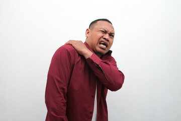 Man feels pain his shoulder isolated studio shot. isolated white background