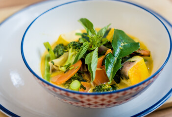 Traditional vegetable green curry with herbs and steamed rice