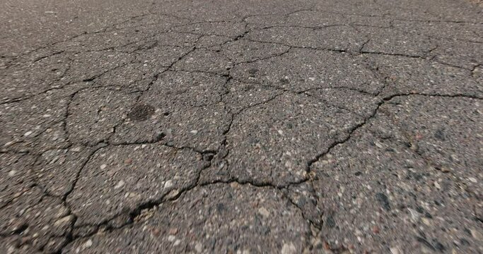 details asphalting of a road , a part of a highway covered with cracked asphalt