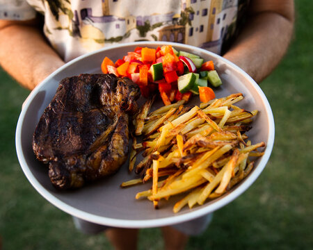 homemade bbq steak, chips and salad on a plate