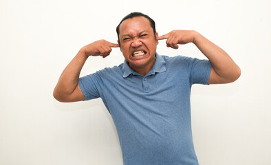 Fototapeta premium portrait of man covering his ears because of noise