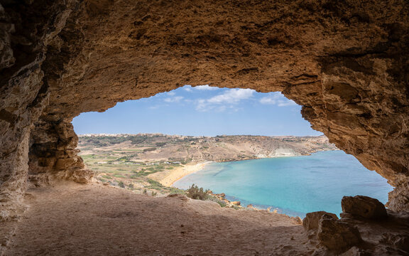 Gozo Island Malta,  View of Ramla Bay, from inside Tal Mixta Cave Gozo looking out over the blue ocean on a bright day.