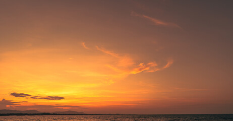 Sunset Sky clouds over horizon sea landscape in the evening summer season background, dramatic colorful orange, yellow sunlight fluffy after sundown on twilight, dusk sky backgrounds  