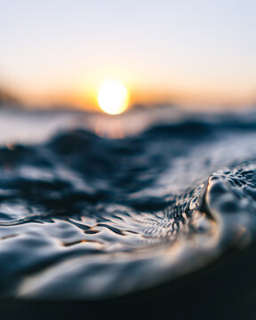 Macro shot of water surface in orange sunset