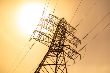 Metal electric pole against the backdrop of the sunset