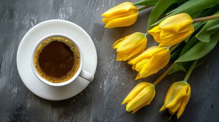 A cup of coffee with yellow tulips bouquet on table