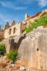 Ancient wall of the ruined fortress with the blue sky as the background
