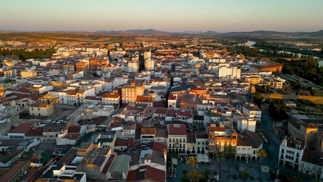 Beautiful orange sunset over Merida city center. Historic and medieval city situated in Badajos province. Panoramic aerial view of the old town center. Drone going forward. Travel destination.
