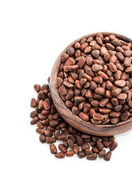 Pine nuts in wooden bowl isolated on white background