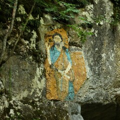 The icon of the saint on the rock in front of the cave