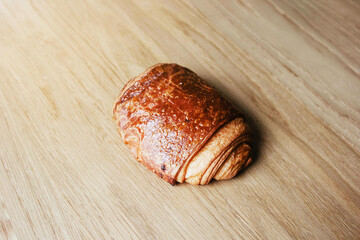 Golden Brown Pain au Chocolat on Wooden Table. Close-Up View of French Pastry. Pain au chocolat