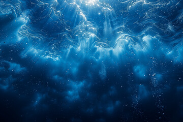 Abstract blue background under the sea with light passing through it.