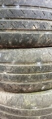 Old used tyres stack at a mechanic shop