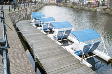 white pedal boats on a canal in the netherlands