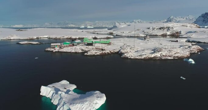 Lonely polar station on Antarctica ocean coast. South Pole science research Vernadsky base aerial view. Global warming, climate change, wild nature exploration. Antarctic travel expedition discovery