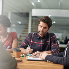 Creative man, writing and meeting with team for proposal, ideas or notes in project discussion at...