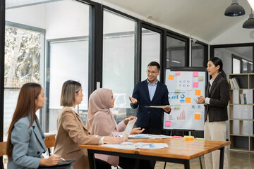 Obraz premium Asian business group discussing graph work at the office..