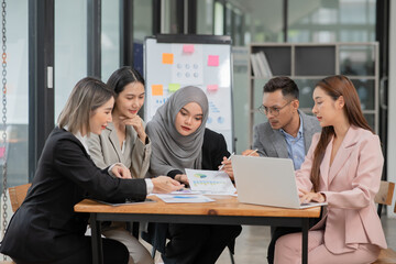 Group of Asian businessmen discussed and presented business graphs in the conference room.