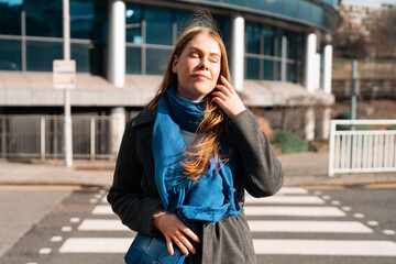 Fototapeta premium Woman Walking in Crosswalk on Sunny Day in City