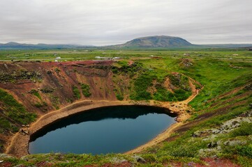 Fototapeta premium Visitors walking the volcano crater lip in Grimsnes-og Grafningshreppur