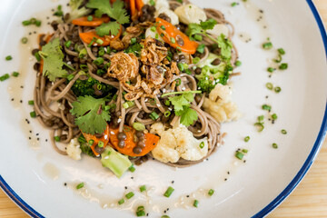 Japanese buckwheat pasta with lentils and vegetables in a bowl