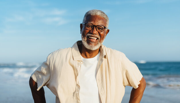 Joyful senior man smiling at the beach - Powered by Adobe