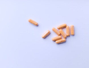 Lutein capsules. Dietary supplement on bright paper background. Soft focus. Close up. Copy space.	