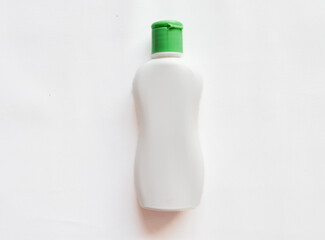 Shampoo bottle with green cover on white background