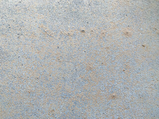 A white wall with a hole in it. The wall is cracked and has a rough texture