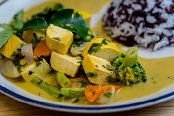 Traditional vegetable green curry with herbs and steamed rice