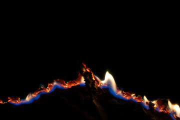 burning paper, glowing edge of paper on a black background.