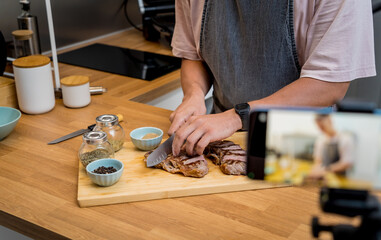 The chef is broadcasting live from workshop how to prepare a beef steaks on the electric grill