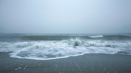  A vast expanse of water shrouded in fog, waves ebb and flow One figure swims amidst; another stands waist-deep