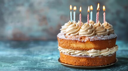 A layered birthday cake topped with lit candles and frosting, set against a textured blue background.