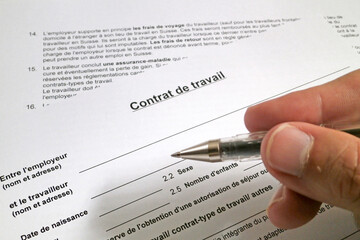 Fototapeta premium Man filling out a Swiss employment contract form