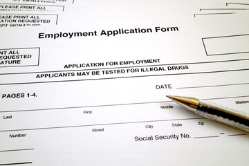 Employment application form and a ballpoint pen