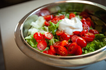 Tomato and green lettuce salad in a bowl
