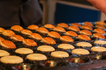 Process of Poffertjes - traditional small Dutch pancakes - making.