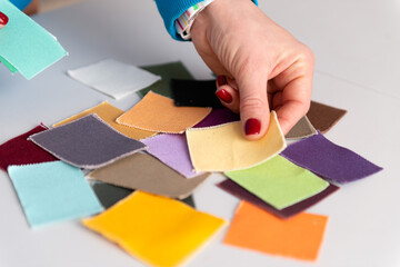 person holding color samples of cotton fabric