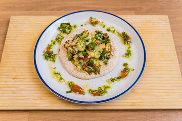 Tasty bean porridge with cauliflower and vegetables on white plate