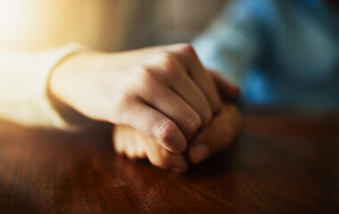 Support, care and trust with hands of people at wooden table together for hope, empathy and love....