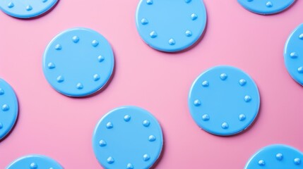 Fototapeta premium Blue plastic badges for personalization on pink backdrop